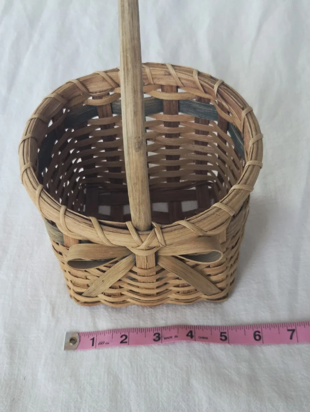 Vintage, Hand-Woven Basket Featuring A Unique Bow Detail And Green Accent